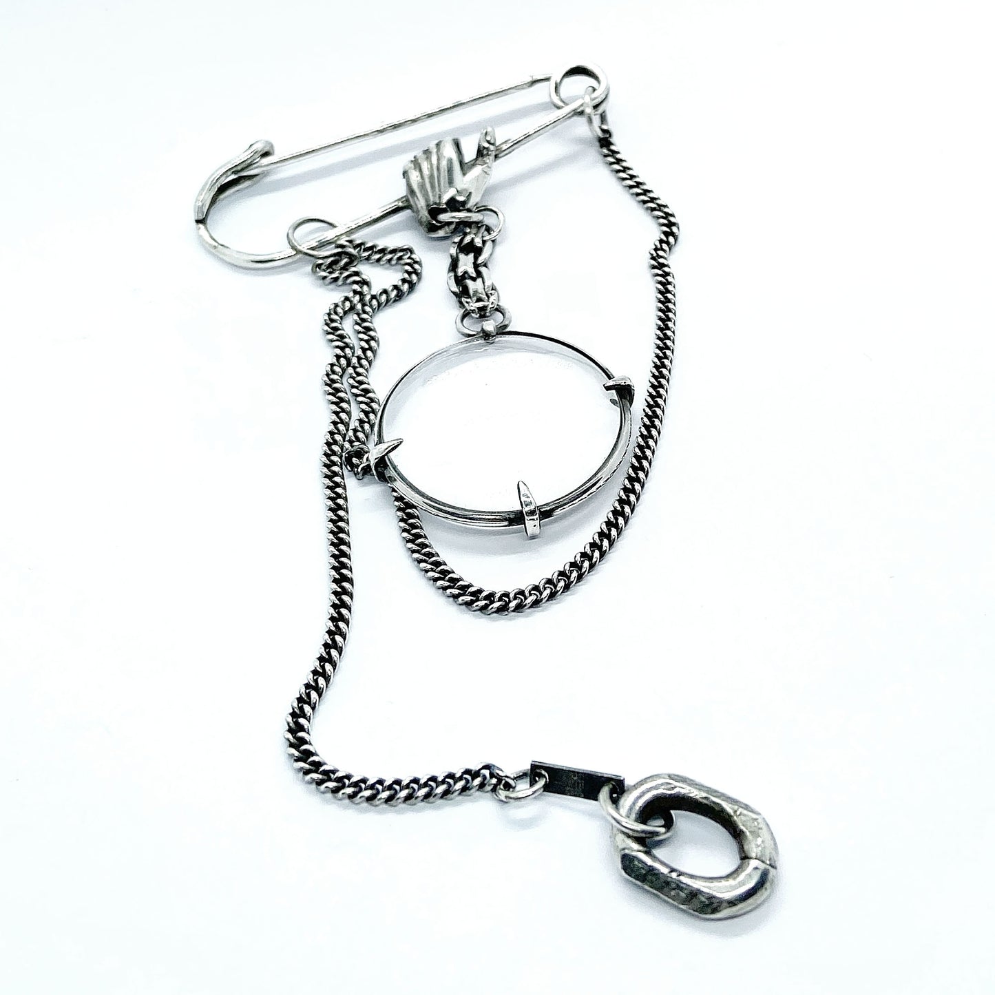 Magnifying glass brooch.
