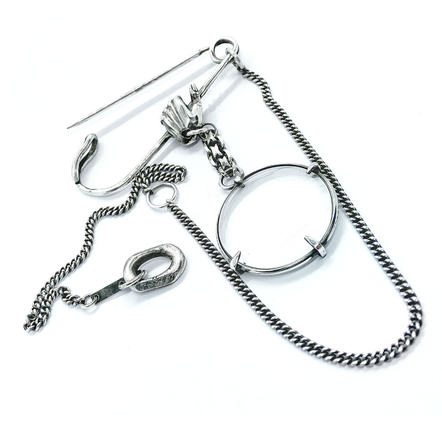 Magnifying glass brooch.